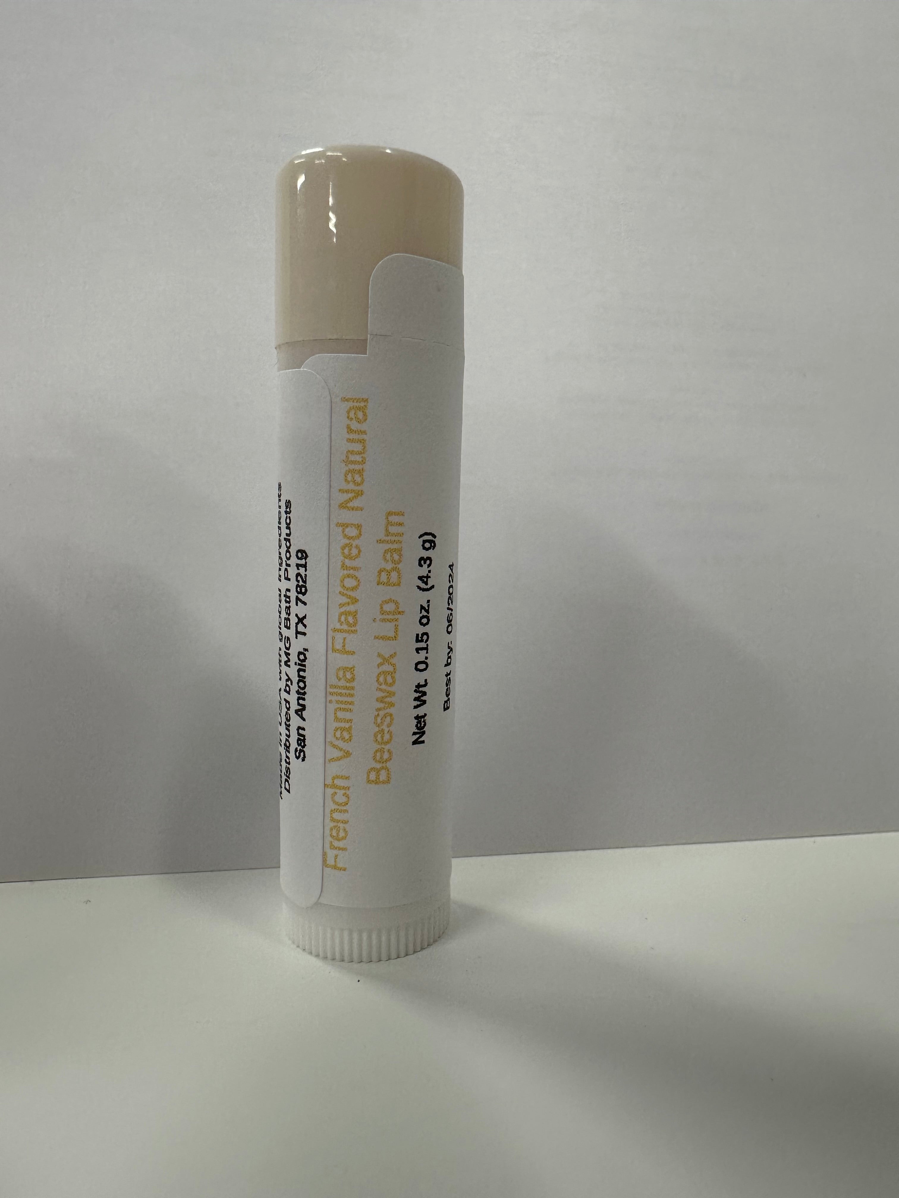 Lip balm in tube with beige colored cap on it.