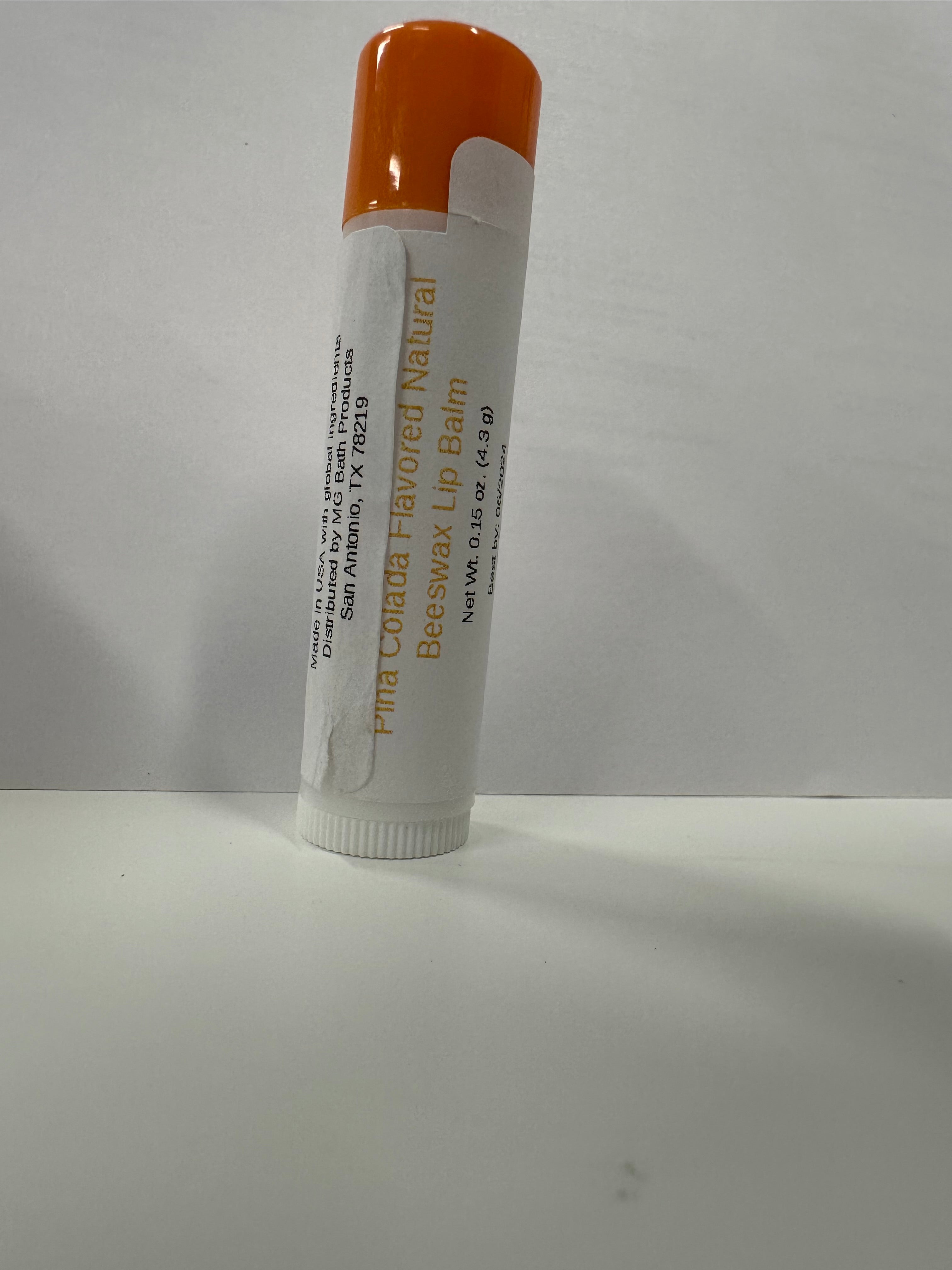 Lip balm in tube with a orange colored cap on it.